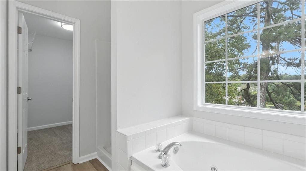 730 Reeves Lake Drive Southwest Marietta, GA 30064 - Photo 14 of 16 a bathroom with a bathtub and a shower