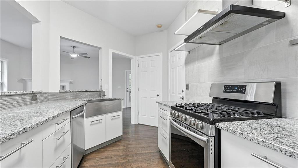 730 Reeves Lake Drive Southwest Marietta, GA 30064 - Photo 2 of 16 a kitchen with granite countertop a sink stove and cabinets
