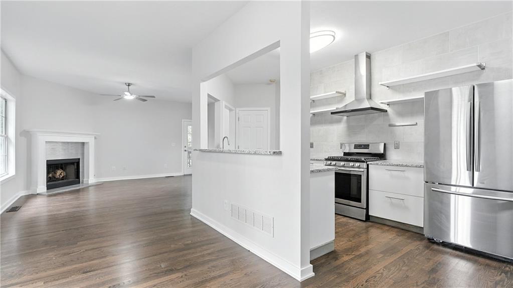 730 Reeves Lake Drive Southwest Marietta, GA 30064 - Photo 3 of 16 a kitchen with a refrigerator and a stove top oven