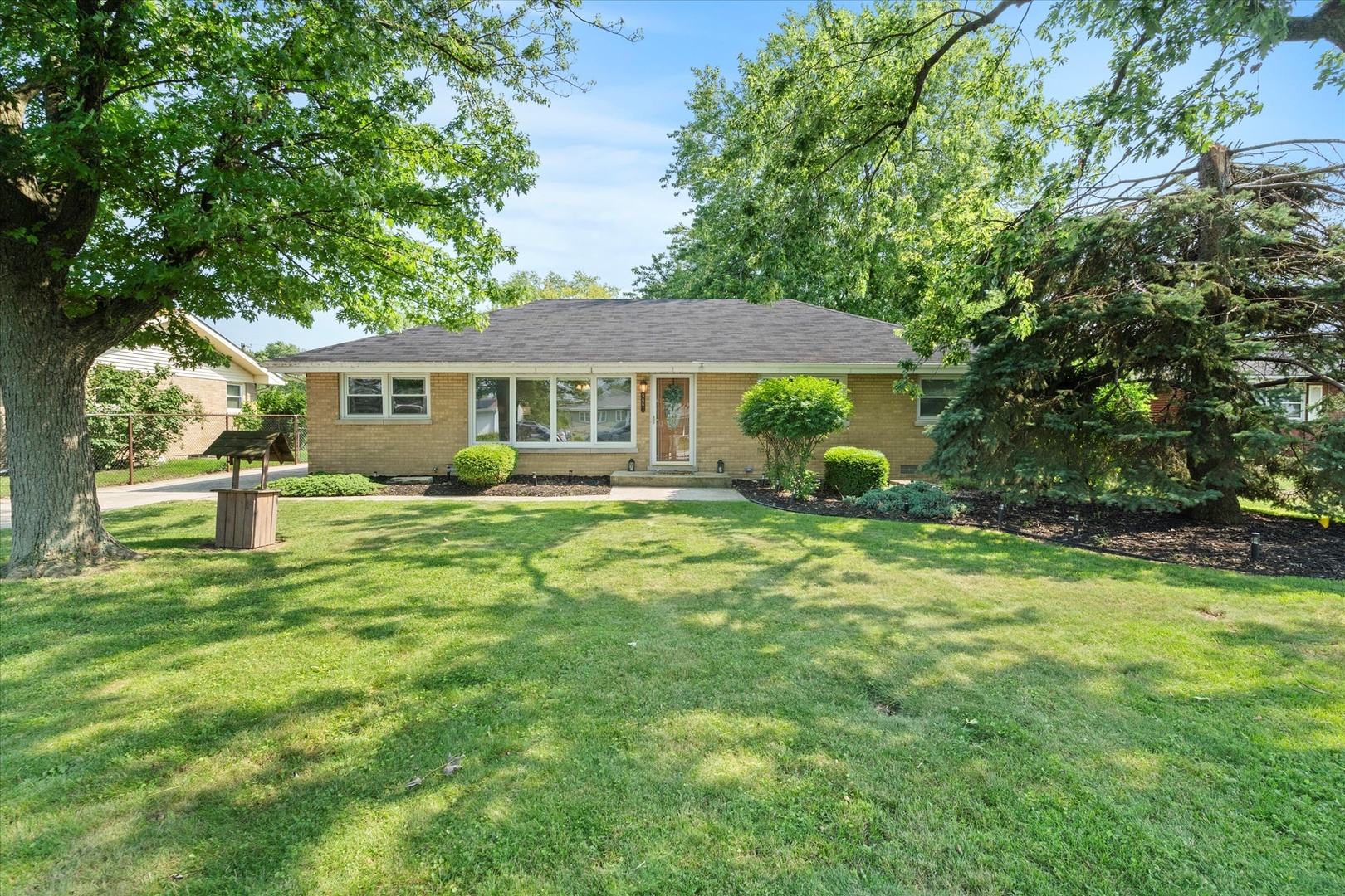 a front view of a house with a garden