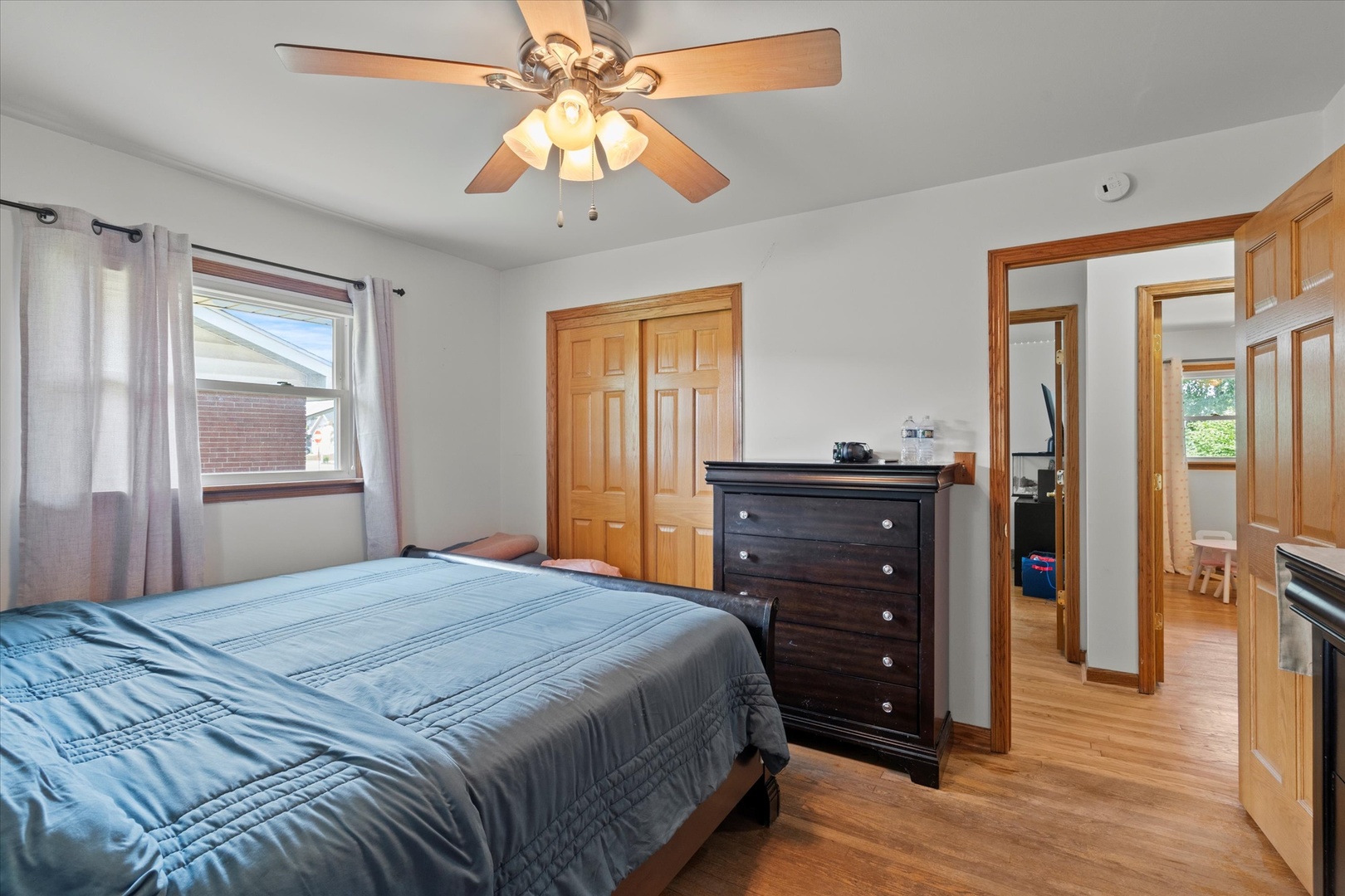 5661 Roosevelt Street Monee, IL 60449 - Photo 12 of 20 a bedroom with a bed and a dresser