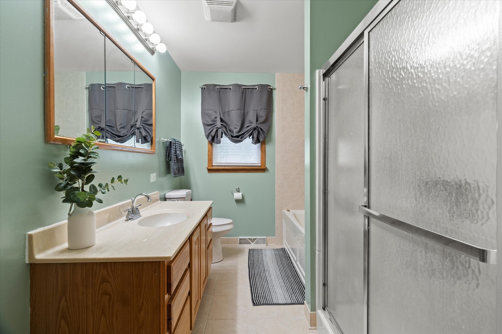 5661 Roosevelt Street Monee, IL 60449 - Photo 13 of 20 a bathroom with a sink and a mirror