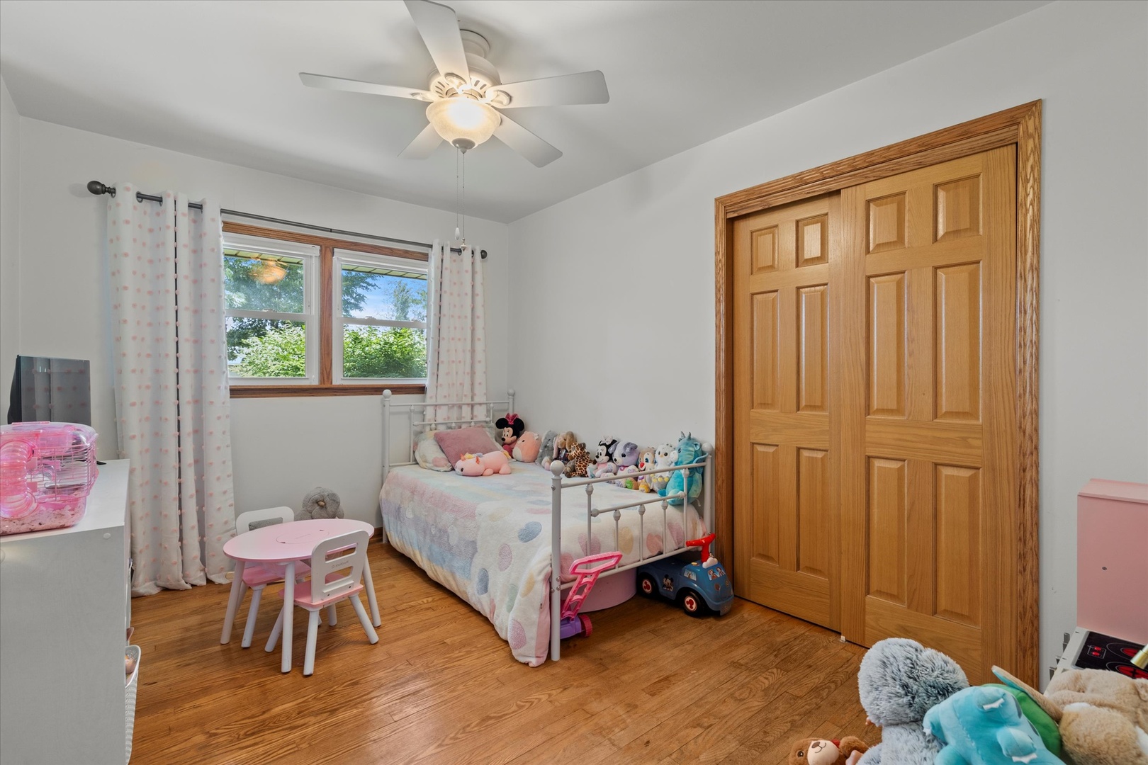 5661 Roosevelt Street Monee, IL 60449 - Photo 14 of 20 a bedroom with a bed and a chandelier