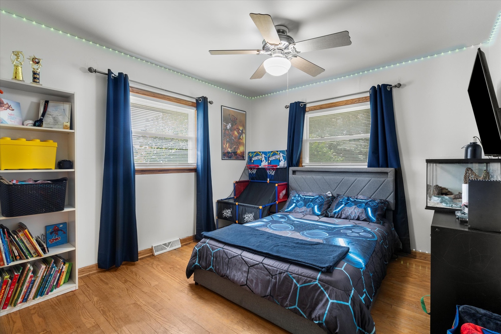 5661 Roosevelt Street Monee, IL 60449 - Photo 15 of 20 a bedroom with a bed a window and flat screen tv