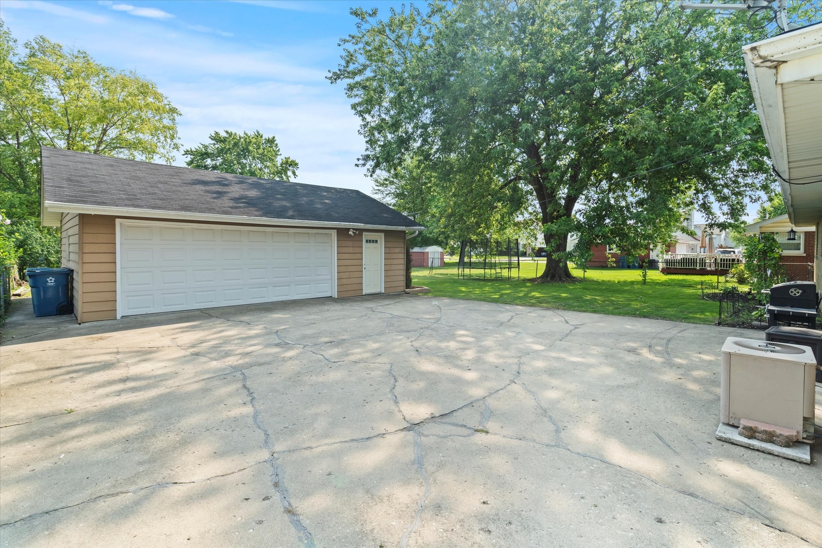 5661 Roosevelt Street Monee, IL 60449 - Photo 16 of 20 a front view of a house with a yard and a garage