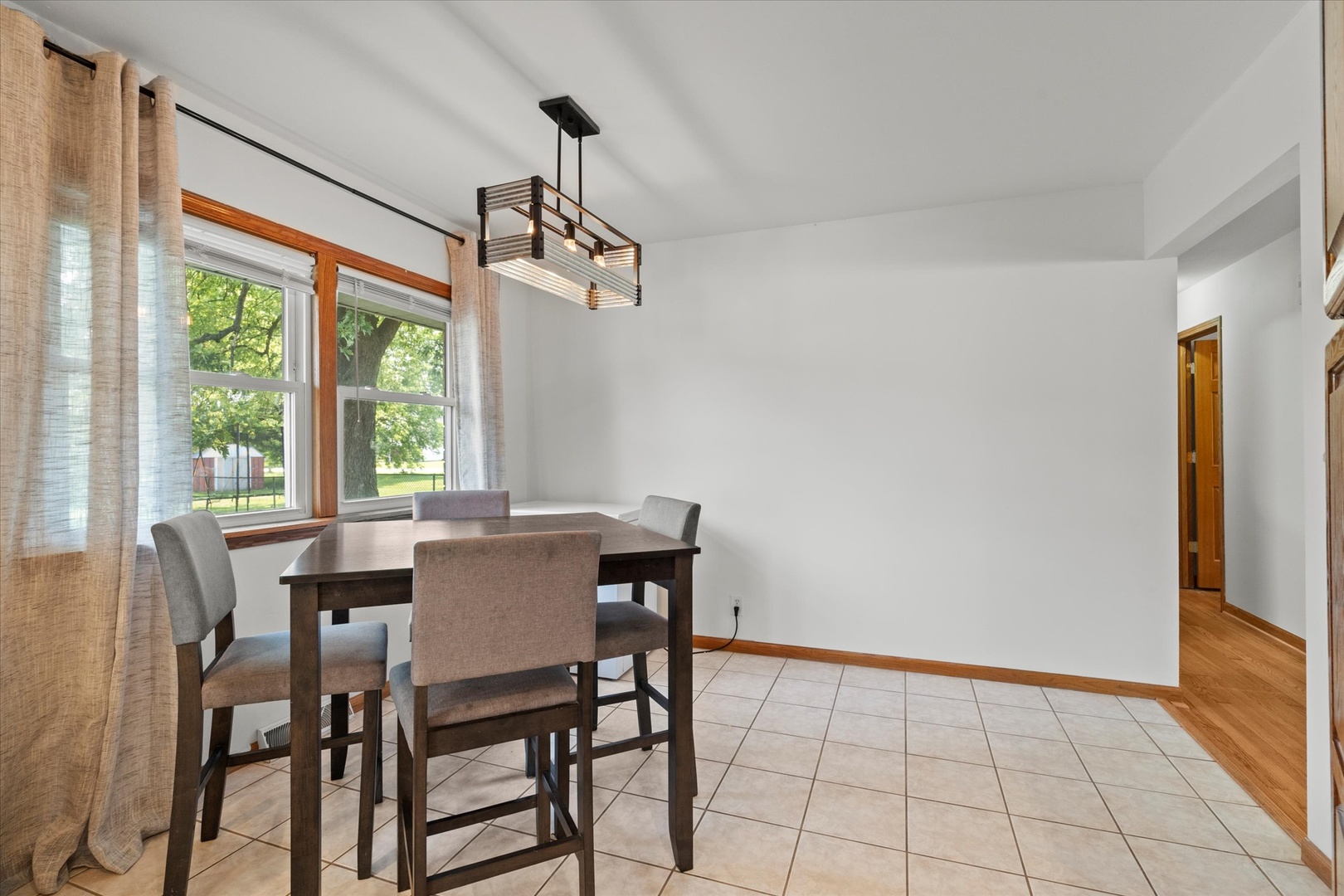 5661 Roosevelt Street Monee, IL 60449 - Photo 6 of 20 a view of a dining room with furniture window and outside view