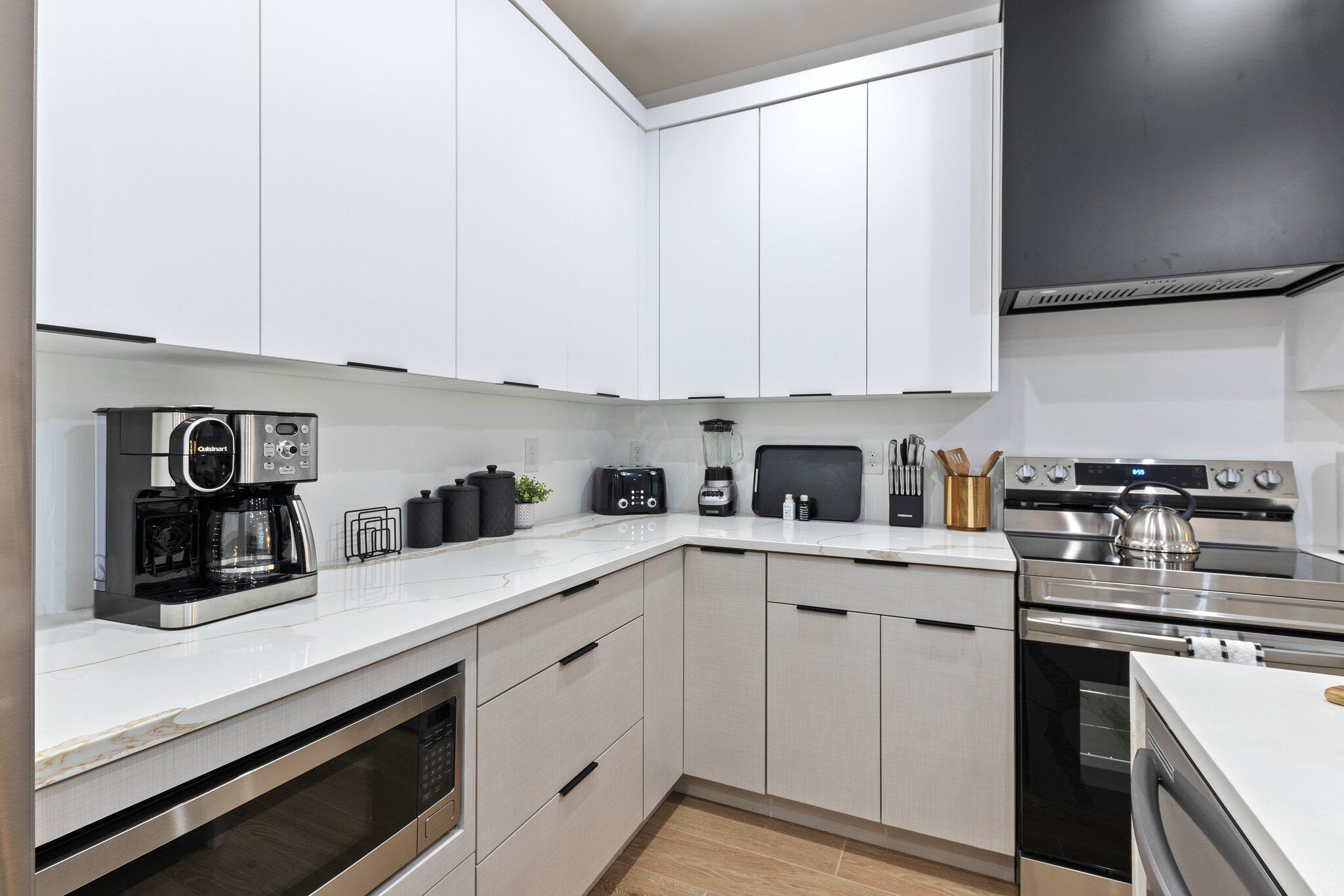 601 Southwest 3rd Street Delray Beach, FL 33444 - Photo 45 of 75 a kitchen with white cabinets and white appliances
