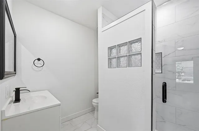 a view of empty room with wooden floor and ceiling fan