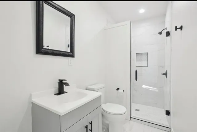 a view of a bedroom with a bed and a window