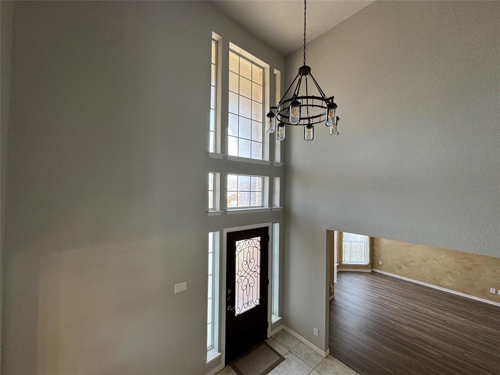 3448 Lark Meadow Way Dallas, TX 75287 - Photo 17 of 39 a view of a hallway with wooden floor and windows