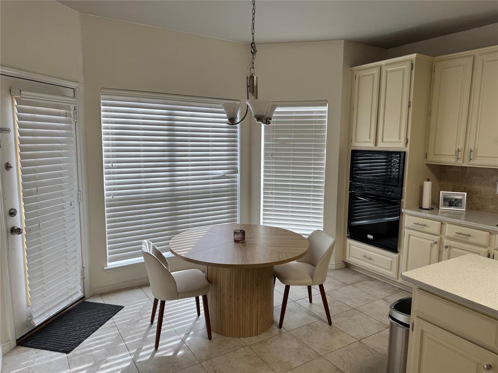3448 Lark Meadow Way Dallas, TX 75287 - Photo 22 of 39 a view of a dining room with furniture