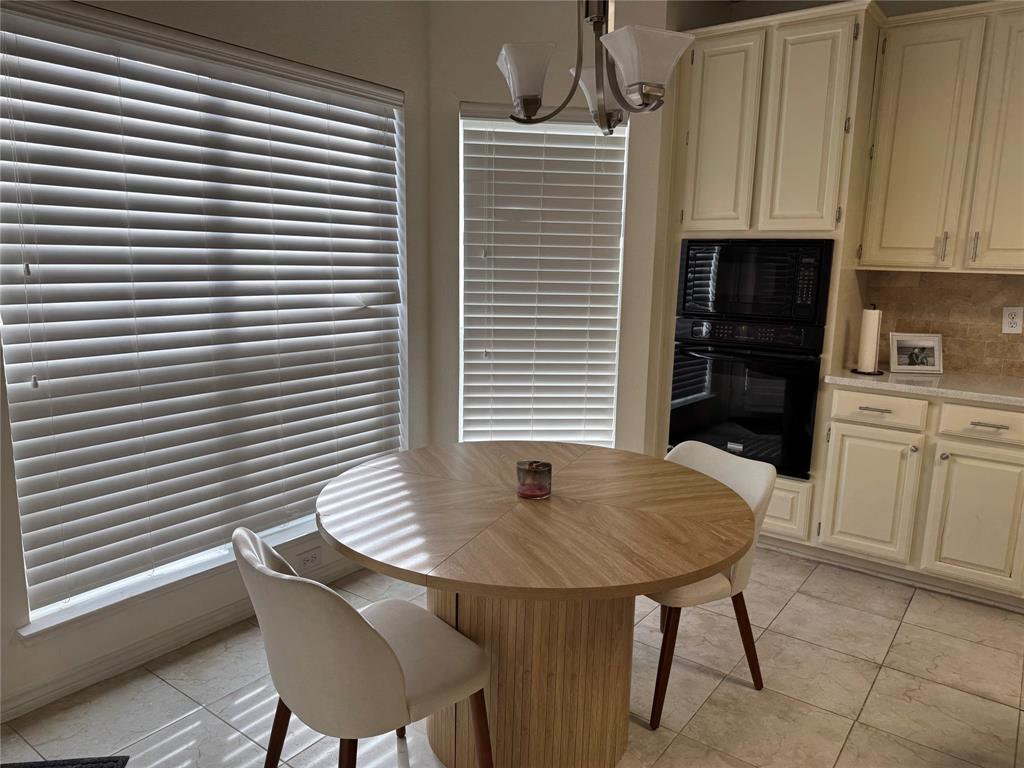 3448 Lark Meadow Way Dallas, TX 75287 - Photo 23 of 39 a kitchen with a table chairs and a refrigerator