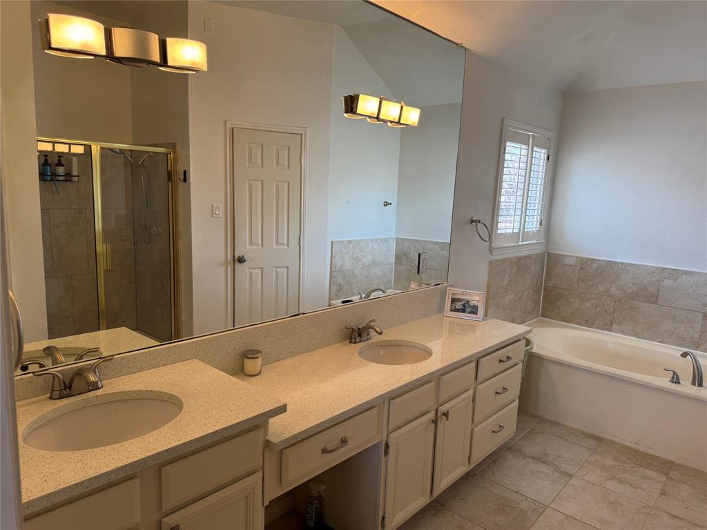 3448 Lark Meadow Way Dallas, TX 75287 - Photo 30 of 39 a bathroom with a tub sink and mirror