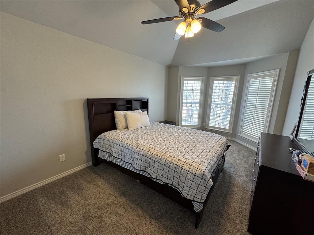 3448 Lark Meadow Way Dallas, TX 75287 - Photo 36 of 39 a bedroom with a bed and window