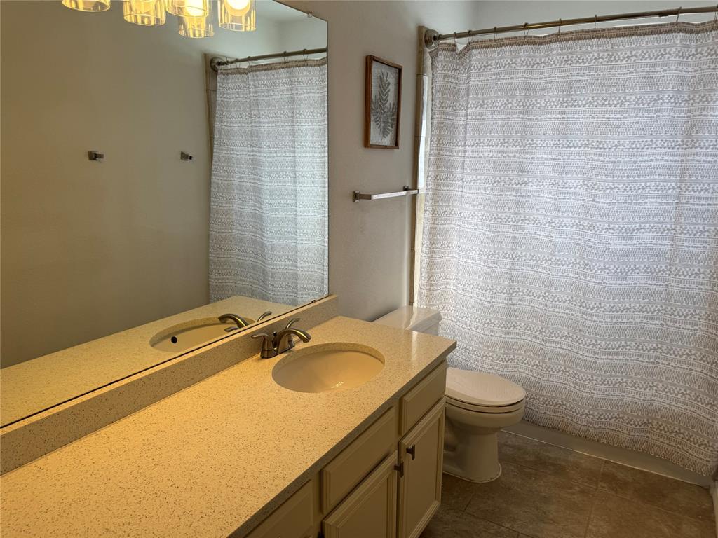 3448 Lark Meadow Way Dallas, TX 75287 - Photo 38 of 39 a bathroom with a sink toilet and shower