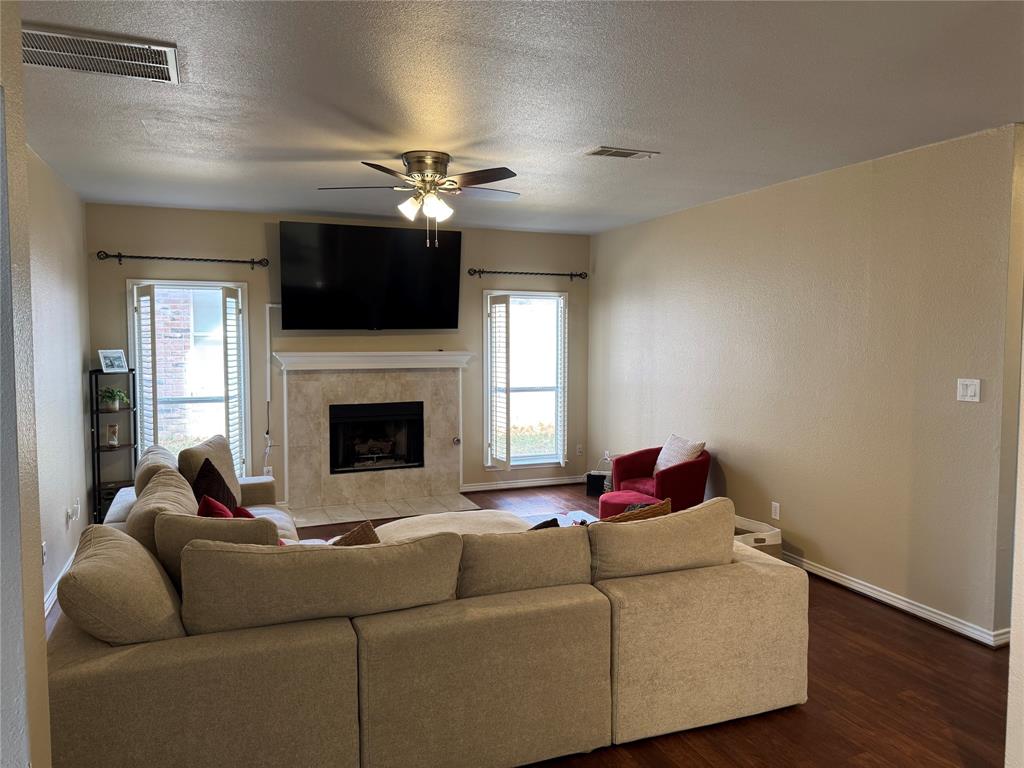 3448 Lark Meadow Way Dallas, TX 75287 - Photo 7 of 39 a living room with furniture a flat screen tv and a fireplace