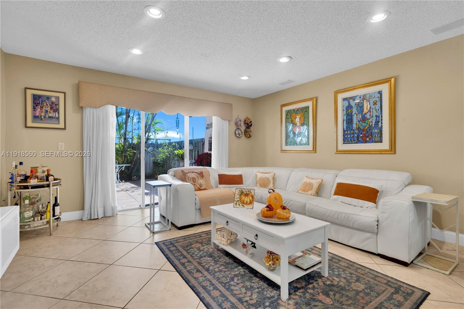 a living room with furniture and a floor to ceiling window