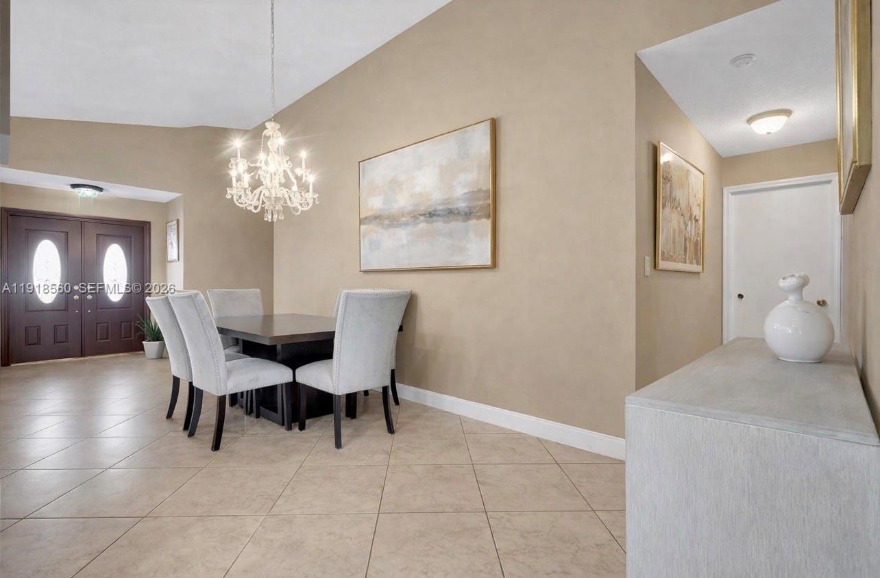 11365 Southwest 143rd Court Miami, FL 33186 - Photo 12 of 40 a dining room with furniture and chandelier