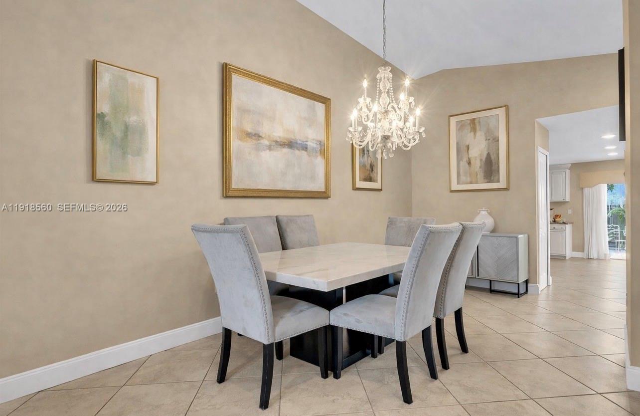 11365 Southwest 143rd Court Miami, FL 33186 - Photo 14 of 40 a view of a dining room with furniture and chandelier