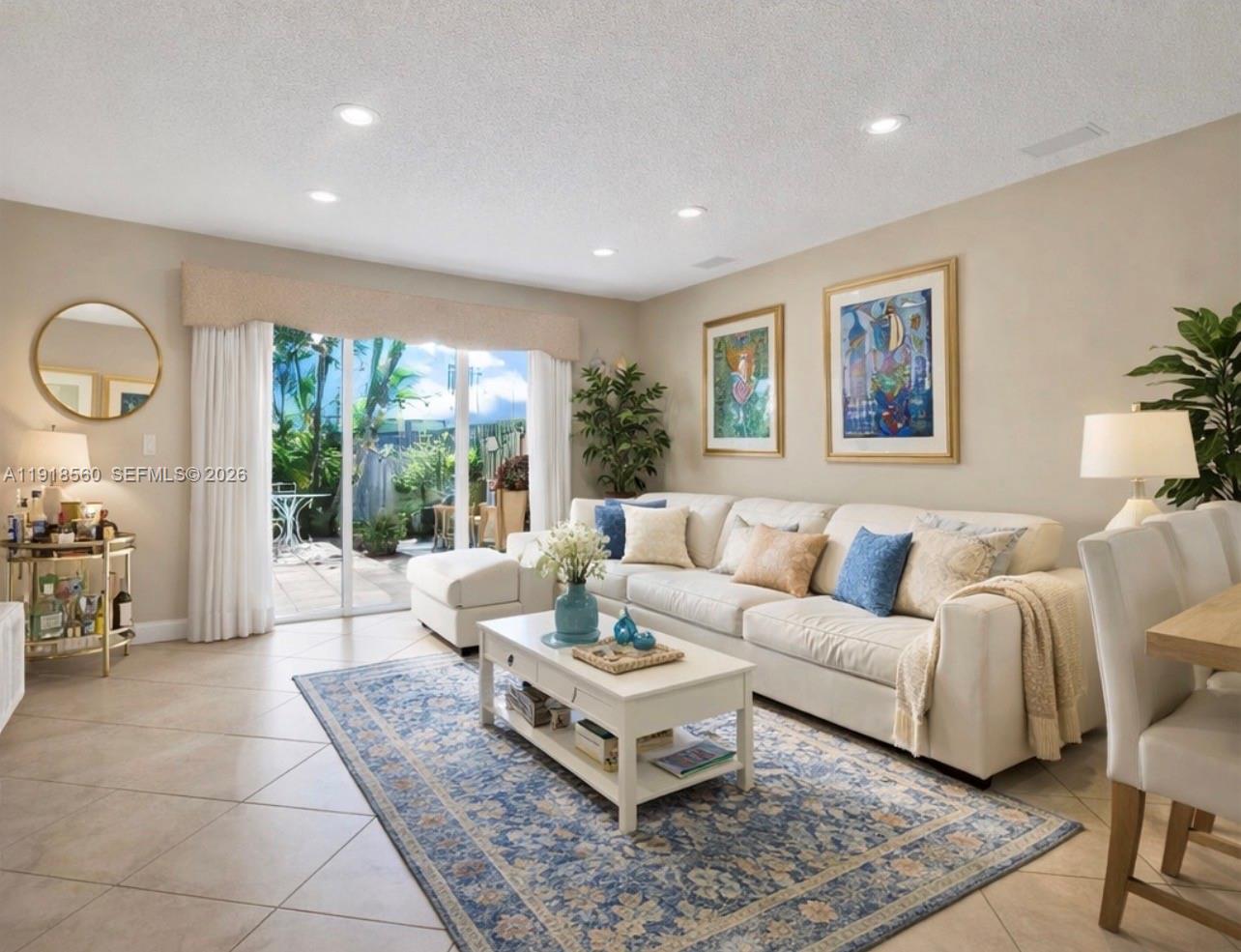 11365 Southwest 143rd Court Miami, FL 33186 - Photo 2 of 40 a living room with furniture potted plant and a large window