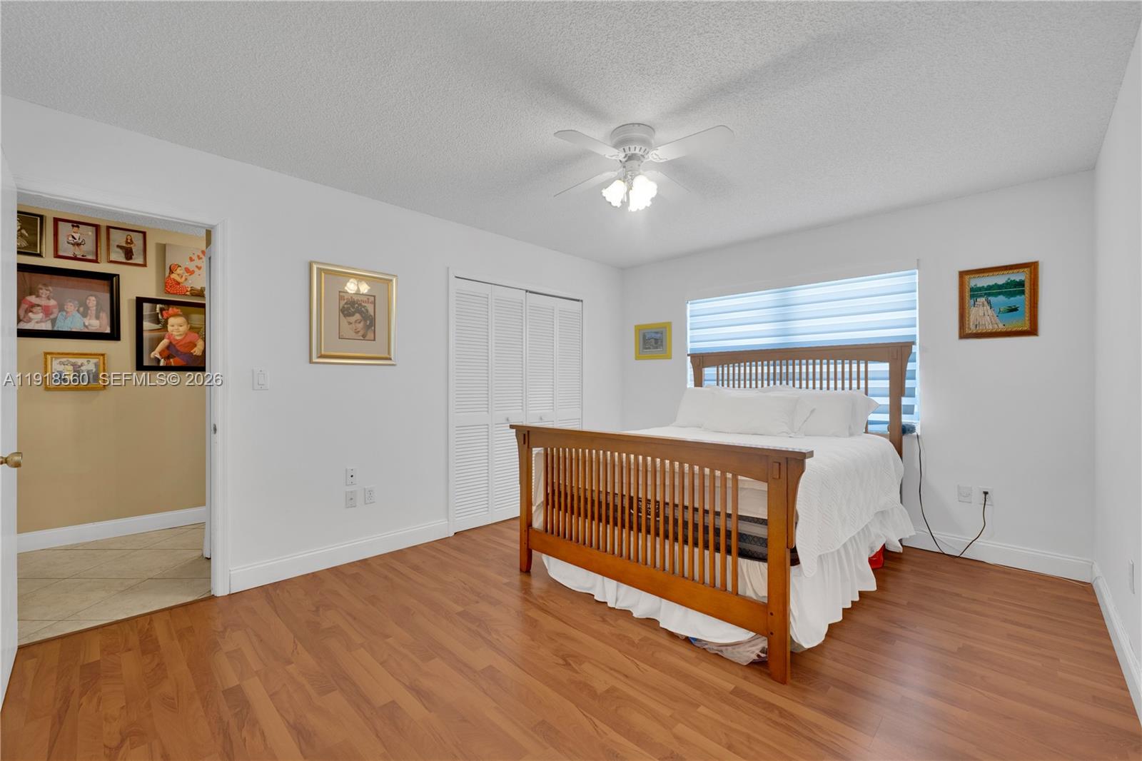 11365 Southwest 143rd Court Miami, FL 33186 - Photo 23 of 40 a view of a bedroom with wooden floor and window