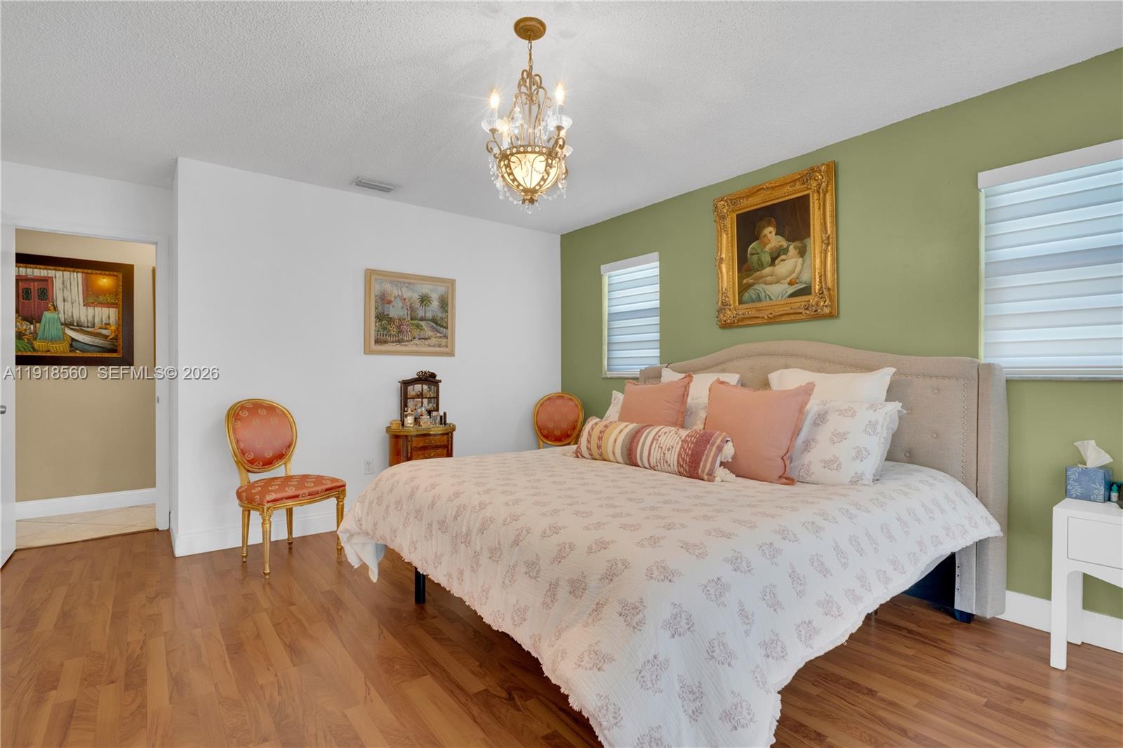 11365 Southwest 143rd Court Miami, FL 33186 - Photo 29 of 40 a bedroom with a bed and a dresser with wooden floor