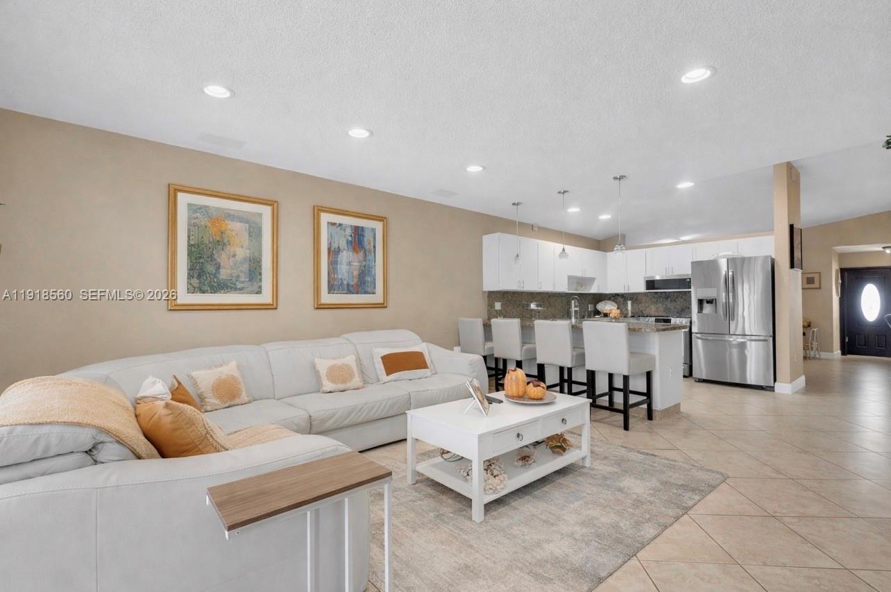 11365 Southwest 143rd Court Miami, FL 33186 - Photo 3 of 40 a living room with furniture and kitchen view