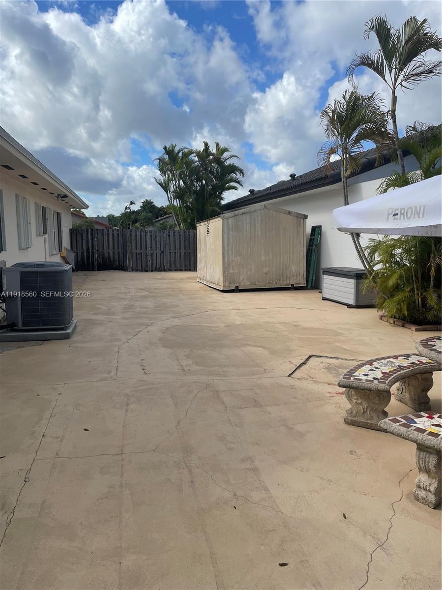 11365 Southwest 143rd Court Miami, FL 33186 - Photo 39 of 40 a front view of a house with a yard and garage