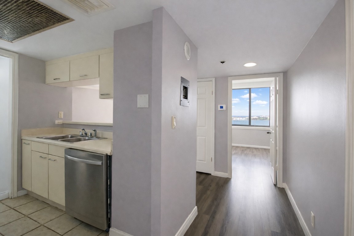 3525 Sage Road, Unit 718 Houston, TX 77056 - Photo 24 of 38 a view of a kitchen with a stove wooden cabinets and wooden floor