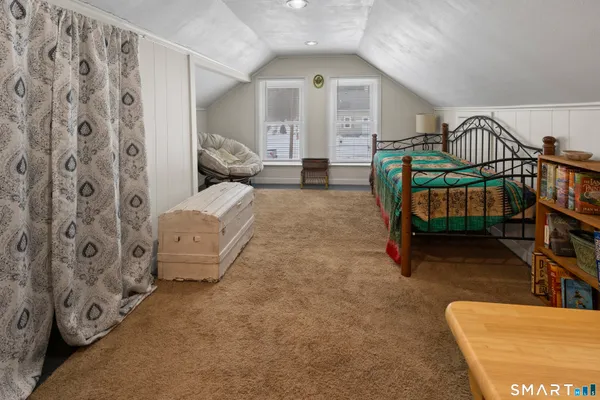 a bedroom with furniture and a large window