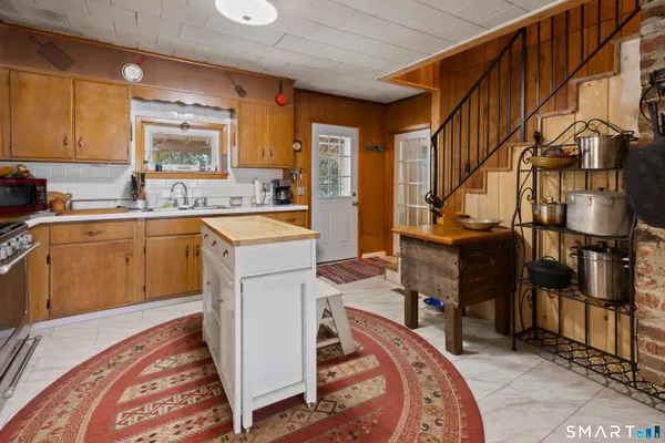 a kitchen with a sink appliances and cabinets