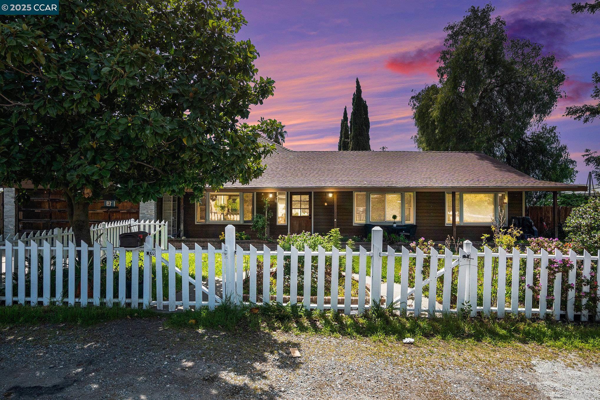 a front view of a house with a garden