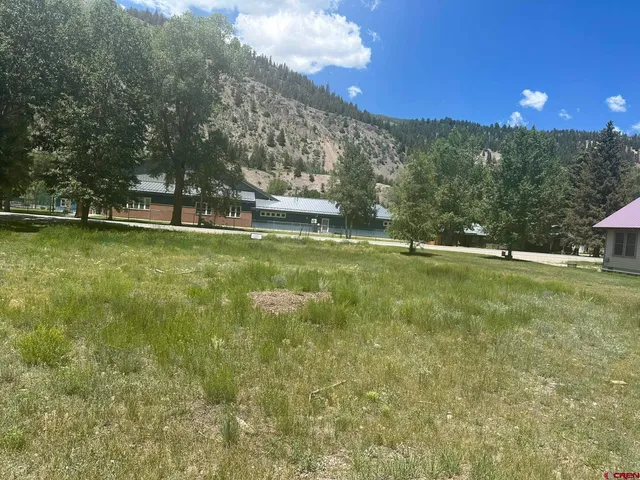 a view of yard with swimming pool and trees