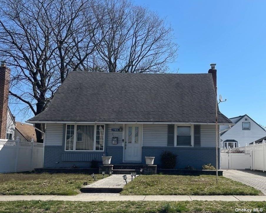 200 Raff Avenue Elmont, NY 11003 - Photo 2 of 4 a front view of a house with a yard