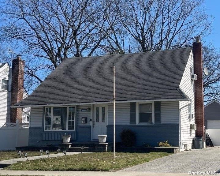 200 Raff Avenue Elmont, NY 11003 - Photo 3 of 4 a house that has tree in front of it