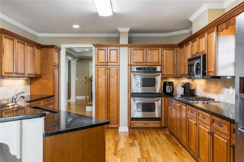 1505 Old John Ward Road Marietta, GA 30064 - Photo 11 of 50 a kitchen with stainless steel appliances granite countertop a stove a sink and a refrigerator