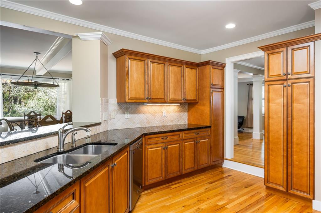 1505 Old John Ward Road Marietta, GA 30064 - Photo 12 of 50 a kitchen with stainless steel appliances granite countertop a sink refrigerator and cabinets
