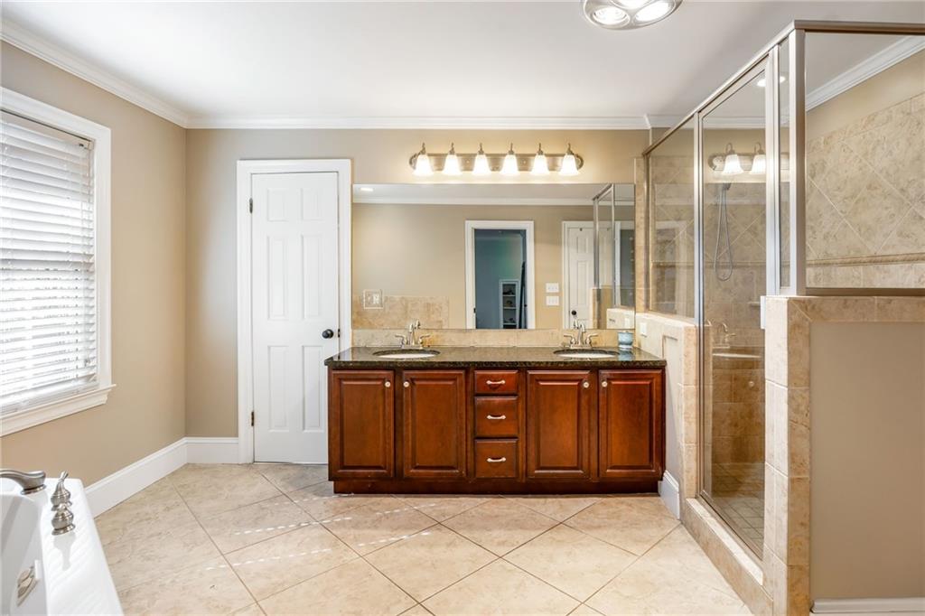1505 Old John Ward Road Marietta, GA 30064 - Photo 20 of 50 a bathroom with a granite countertop tub sink and mirror