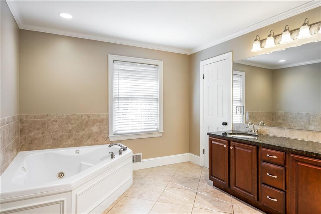 1505 Old John Ward Road Marietta, GA 30064 - Photo 21 of 50 a bathroom with a tub sink and mirror