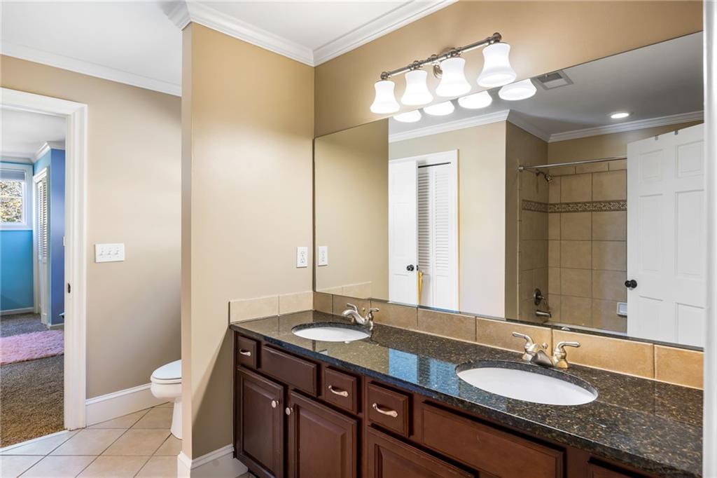 1505 Old John Ward Road Marietta, GA 30064 - Photo 24 of 50 a bathroom with a granite countertop sink a toilet and a mirror