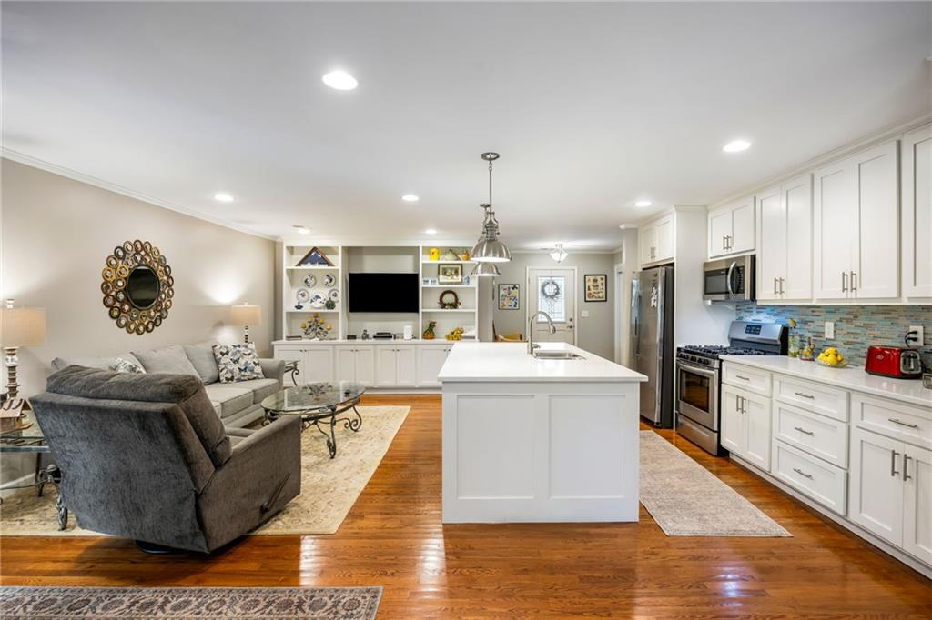 1505 Old John Ward Road Marietta, GA 30064 - Photo 32 of 50 a living room with stainless steel appliances kitchen island granite countertop a stove and a refrigerator
