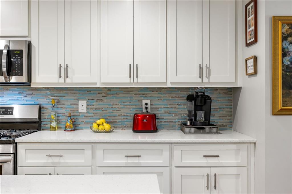 1505 Old John Ward Road Marietta, GA 30064 - Photo 35 of 50 a kitchen with white cabinets and a wooden floor