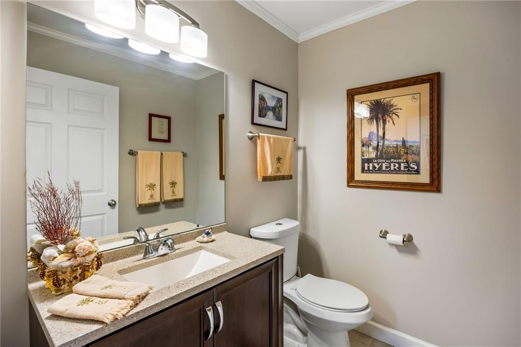 1505 Old John Ward Road Marietta, GA 30064 - Photo 41 of 50 a bathroom with a granite countertop toilet a sink and a mirror