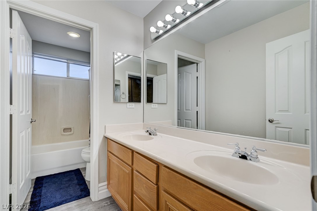 2391 Rainswept Avenue Henderson, NV 89052 - Photo 47 of 62 This bright bathroom features a spacious dual-sink vanity and sleek flooring.