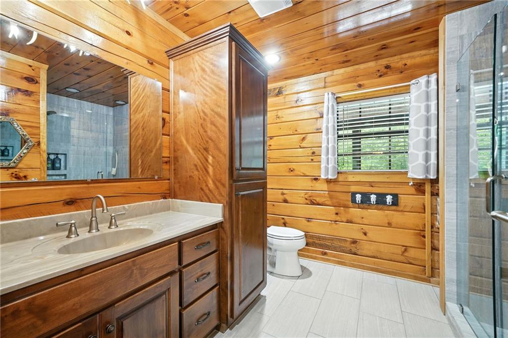 749 Old Federal Road South Chatsworth, GA 30705 - Photo 16 of 45 a bathroom with a granite countertop toilet sink and mirror