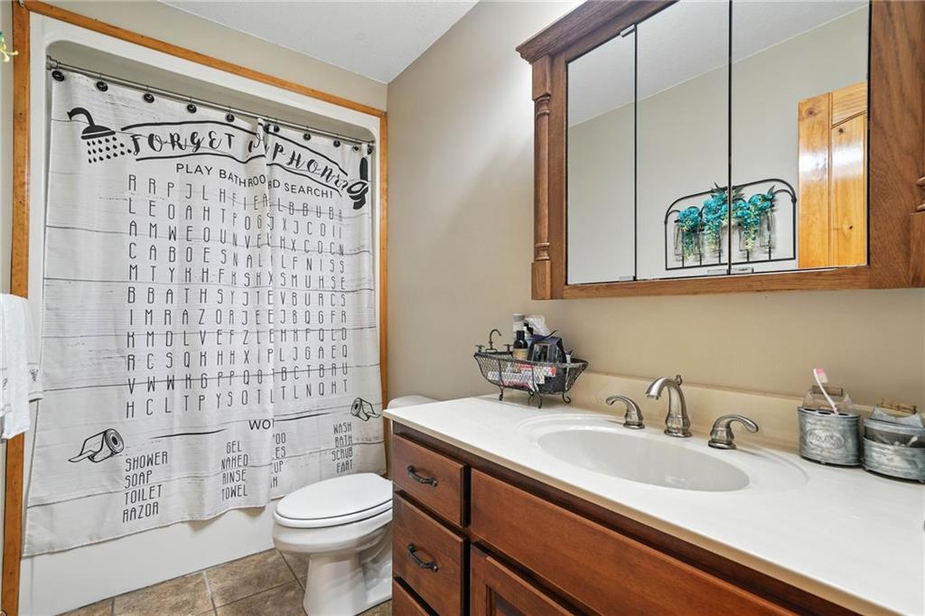 749 Old Federal Road South Chatsworth, GA 30705 - Photo 23 of 45 a bathroom with a sink a toilet and shower curtain