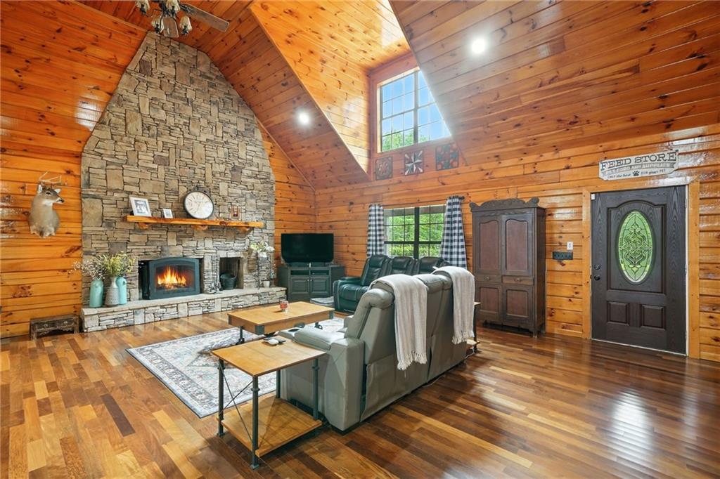 749 Old Federal Road South Chatsworth, GA 30705 - Photo 4 of 45 a living room with furniture a fireplace and a wooden floor