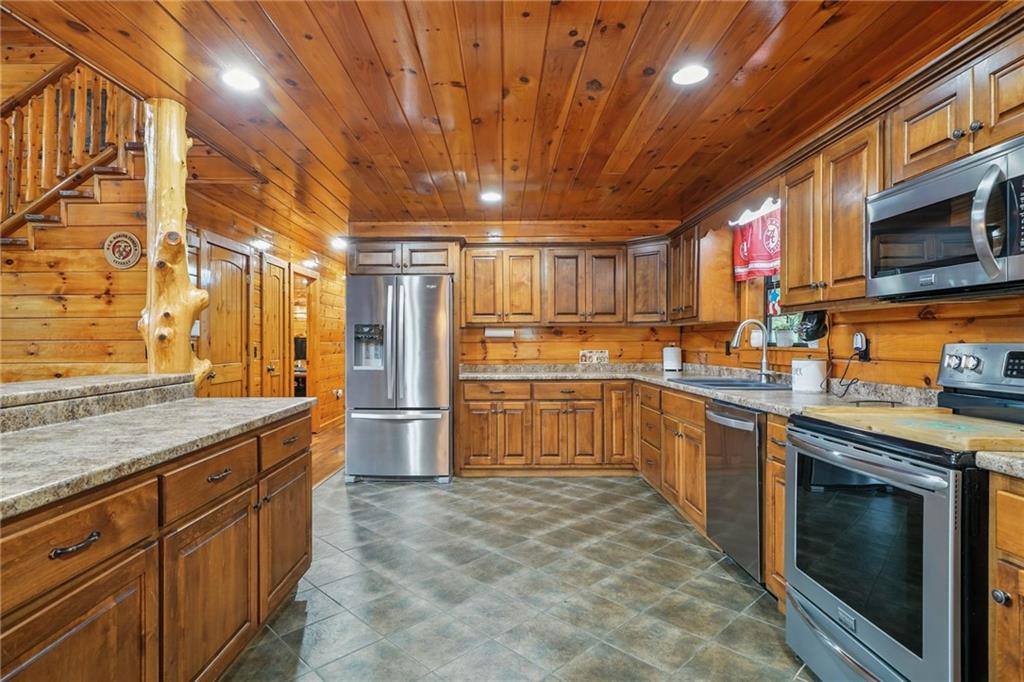 749 Old Federal Road South Chatsworth, GA 30705 - Photo 8 of 45 a large kitchen with stainless steel appliances granite countertop a sink and cabinets