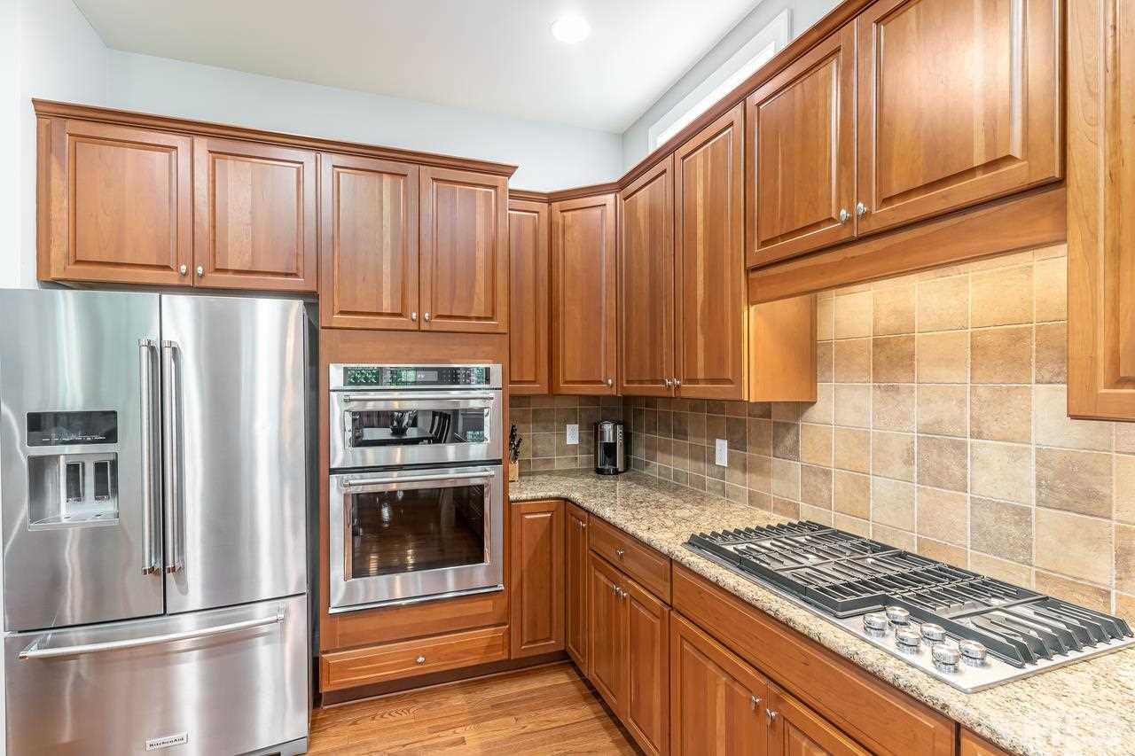 9629 Heathermill Lane Raleigh, NC 27617 - Photo 9 of 28 SS appliances, ceilling can lights and ceramic backsplash.