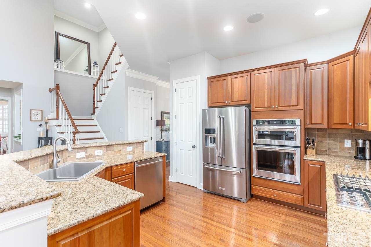 9629 Heathermill Lane Raleigh, NC 27617 - Photo 10 of 28 Granite CTs and breakfast bar. Hardwood floors throughout.